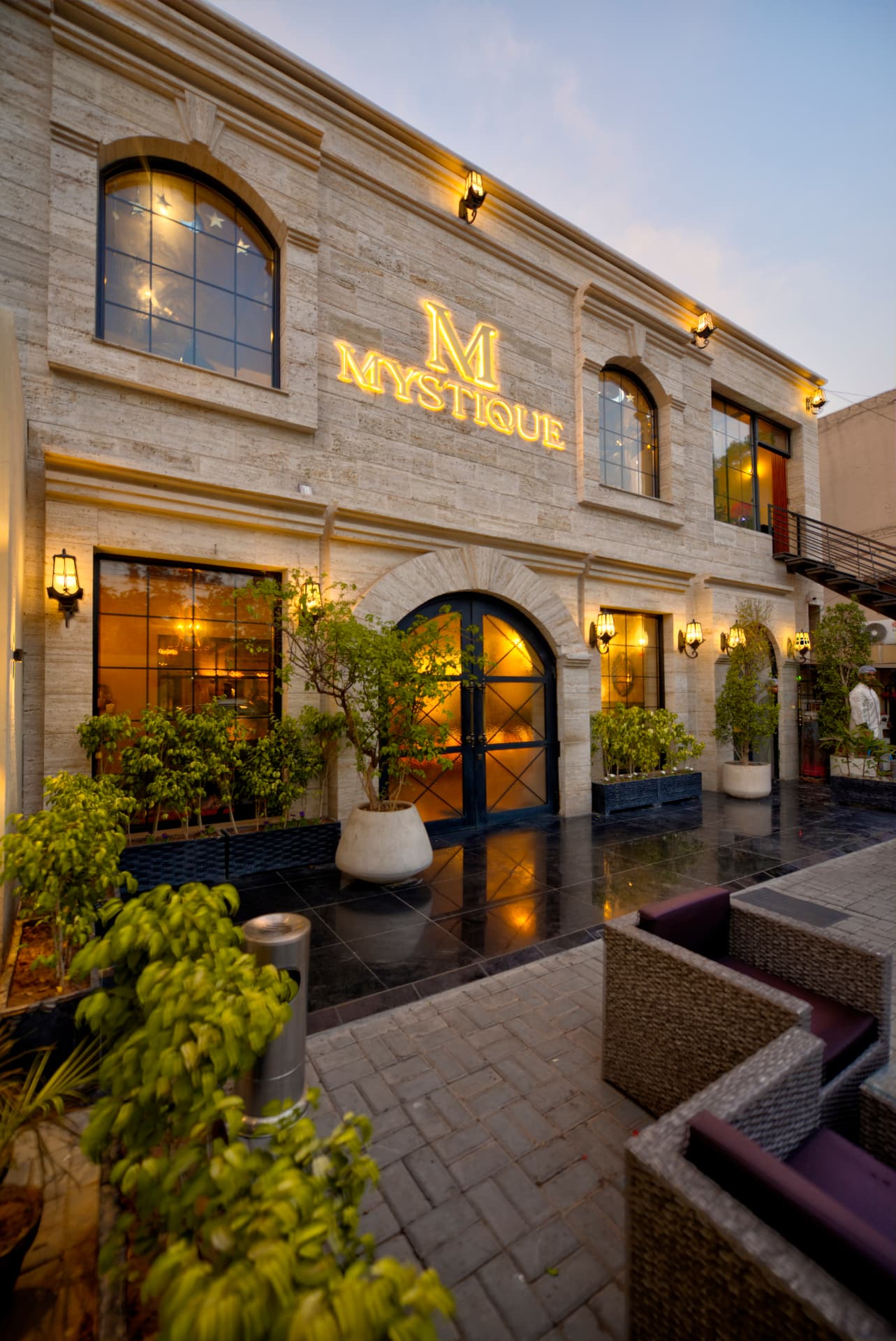 The illuminated Mystique restaurant exterior at dusk