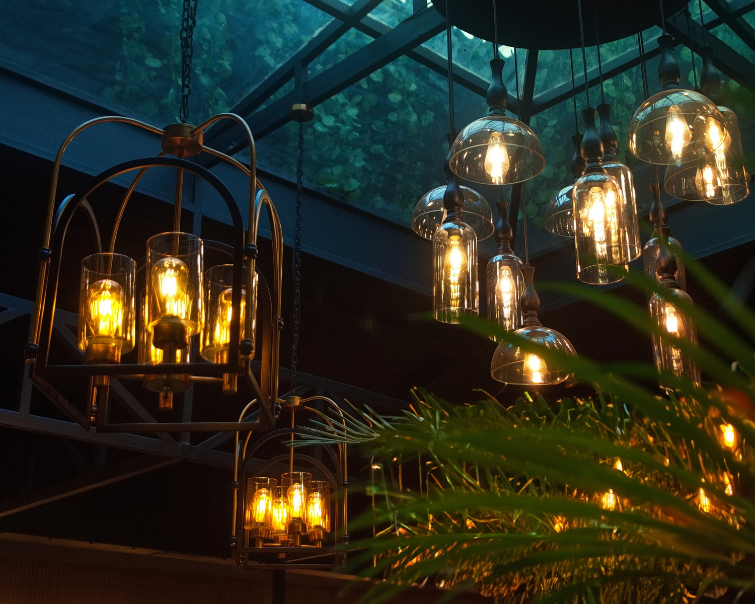 Warm golden lanterns and foliage inside Mystique Restaurants